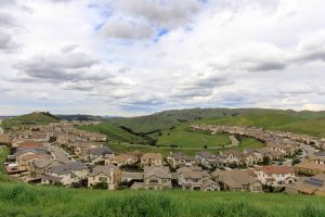 Dublin, California | Residential Homes in Dublin Hills with approaching storm clouds in the winter.